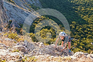 Kid girl climbing mountain.