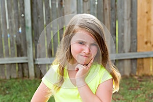 Kid girl with disappoint expression finger thinking photo