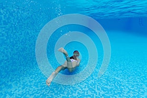 Kid girl diving swimming in pool