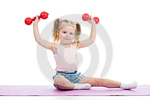 Kid girl doing exercises with dumbbells