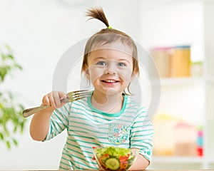 Kid girl eating healthy vegetables food