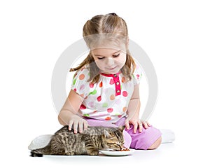 Kid girl feeding cat