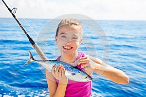 Kid girl fishing tuna little tunny happy with fish catch
