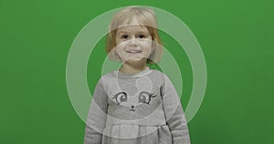 Kid girl on a green screen, chroma key. happy three years old girl