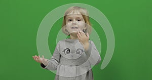 Kid girl on a green screen, chroma key. happy three years old girl