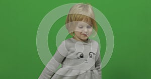 Kid girl on a green screen, chroma key. Happy three years old girl