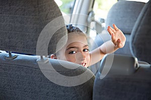 Kid girl happy greeting gesture hand in car indoor