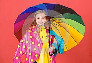Kid girl happy hold colorful umbrella wear waterproof cloak. Enjoy rainy weather with proper garments. Waterproof