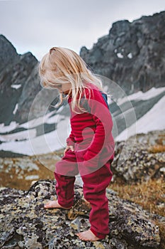 Kid girl hiking barefoot in mountains family travel vacations hiking trip