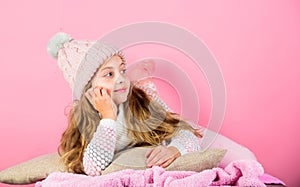 Kid girl knitted hat and scarf. Winter accessory concept. Girl long hair dream pink background. Kid dreamy wear knitted