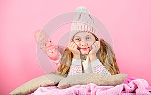 Kid girl knitted hat and scarf. Winter accessory concept. Girl long hair dream pink background. Winter season concept