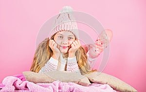 Kid girl knitted hat and scarf. Winter accessory concept. Girl long hair dream pink background. Winter season concept