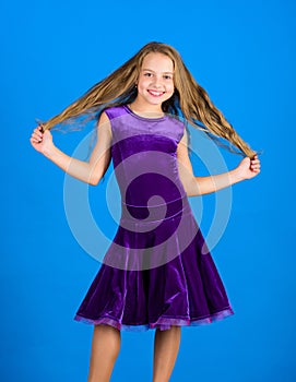 Kid girl with long hair wear dress on blue background. Hairstyle for dancer. How to make tidy hairstyle for kid. Things