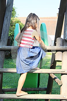 Kid - girl mounting on stairs to slide