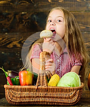 Kid girl near basket full of fresh vegetables harvest rustic style. Harvest festival concept. Farm market fall harvest