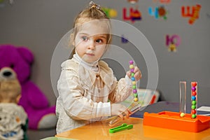 Kid Girl Playing with Learning Bead Toy