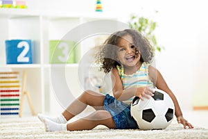 Kid girl playing toys at kindergarten room