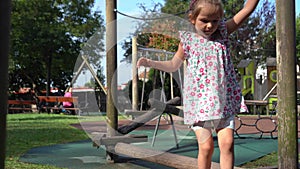 kid girl playing on the wooden playground