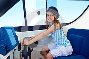 Kid girl pretending be a captain sailor cap in boat