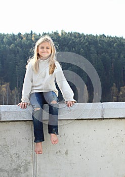 Kid - girl sitting on railing