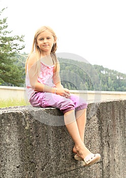 Kid - girl sitting on railing