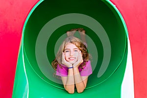 Kid girl smiling in the park playground relaxed