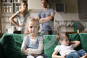 Kid girl upset, offended or bored ignoring parents and brother photo