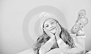 Kid girl wear cute knitted fashionable hat and scarf accessory. Winter accessory concept. Girl long hair dream pink