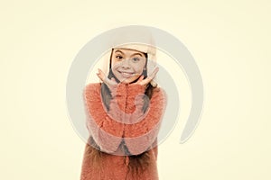 Kid girl wear hat with ear flaps white background. Soft furry accessory. Tips for caring for fur garments. Child long