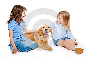 Kid girls with Golden retriever puppy isolated