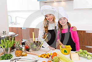 Kid girls junior chef friends hug together at cooking school photo