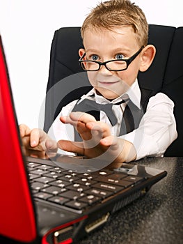 Kid in glasses and laptop photo