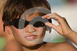 Kid with goggles ready to go for a swim