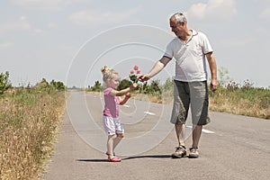 Kid and grandfather on the road