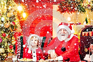 Kid and and grandfather writting a christmas letter to santa claus. Christmas helper child writing letter to Santa Claus