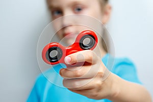 Kid hand holding popular fidget spinner toy