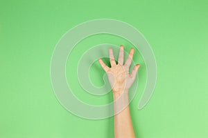 Kid hand palm or showing five fingers on green background