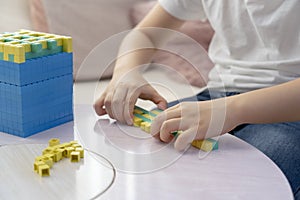 Kid hand using plastic block counting number, Montessori classroom material for children learning of mathematics at home, Home