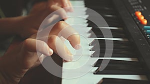 Kid hands playing music on piano