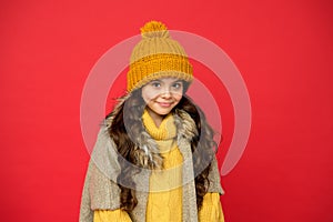 Kid with happy face wearing warm winter clothing and get ready for holidays, cold weather