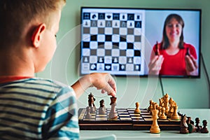 Kid having online chess lesson, e-education, distance learning