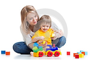 Kid with his mom play building blocks toys