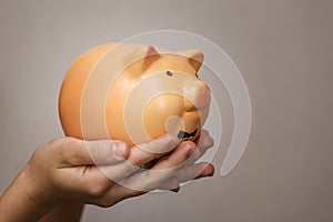 Kid hold a pig bank, a saving money for future education concept. Little girl holding a piggy bank