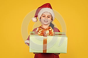 Kid hold present box yellow background. Merry Christmas and happy holidays. Dreams come true. Winter holidays. My happy