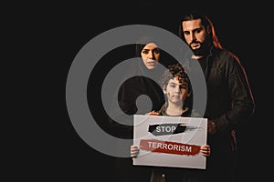 Kid holding card with stop terrorism