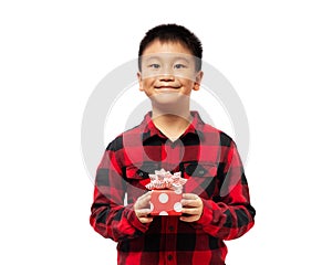 Kid holding christmas gift box with smile wearing red shirt