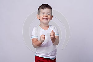 Kid holding discount white card in  hand. Kid with credit card. Little boy showing empty blank paper note copy space.