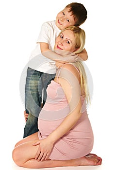 Kid hugging his pregnant mother
