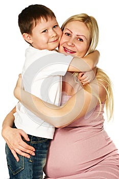 Kid hugging his pregnant mother