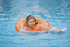 Kid with inflatable ring in swimming pool. Summer vacation. Summer holiday. Summertime kids weekend. Child in swiming